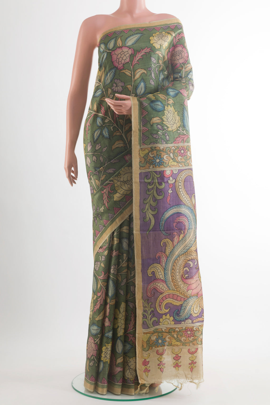 Green Tussar Saree with kalamkari Print on the body and Zari Border.  displayed on a mannequin