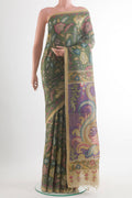 Green Tussar Saree with kalamkari Print on the body and Zari Border.  displayed on a mannequin
