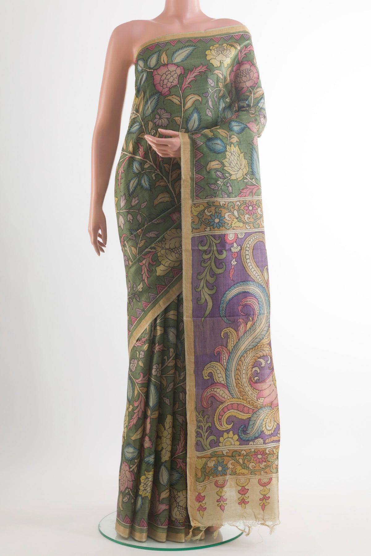 Green Tussar Saree with kalamkari Print on the body and Zari Border.  displayed on a mannequin