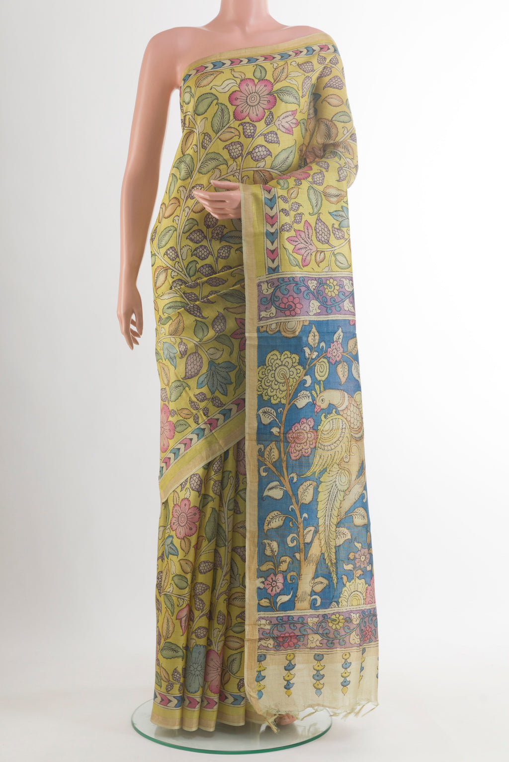 Yellow Tussar Saree with kalamkari Print on the body and Zari Border.  displayed on a mannequin