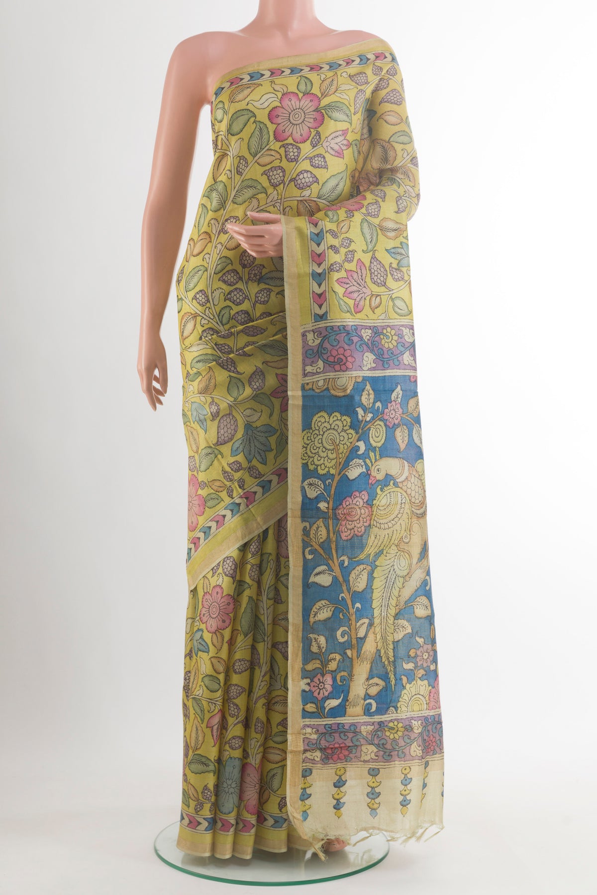 Yellow Tussar Saree with kalamkari Print on the body and Zari Border.  displayed on a mannequin