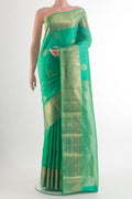 Pure Silk Green Kanjivaram Saree with Zari Butta on the body and Zari Border.  displayed on a mannequin