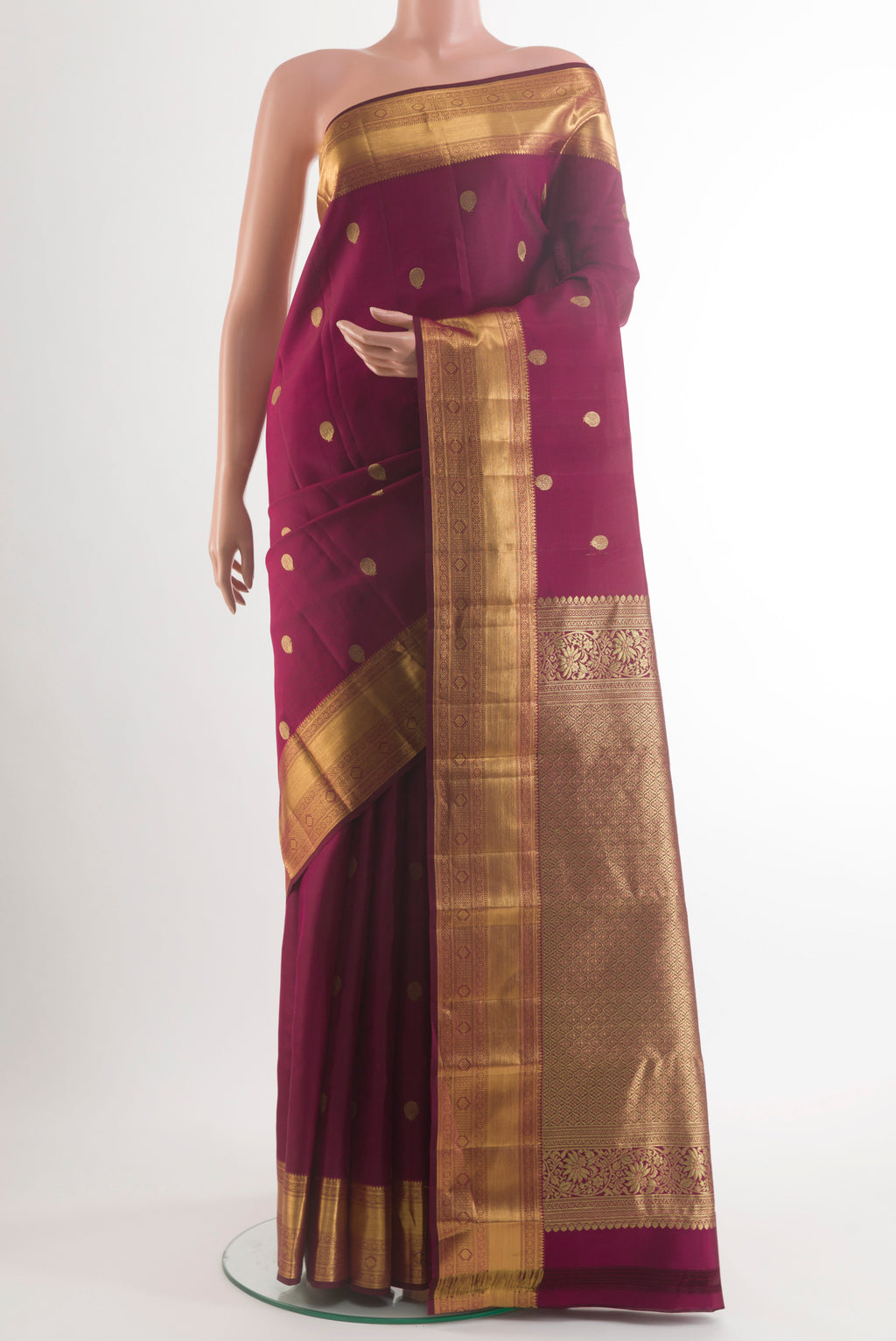Pure Silk Maroon Kanjivaram Saree with Zari Butta on the body and Zari Border.  displayed on a mannequin