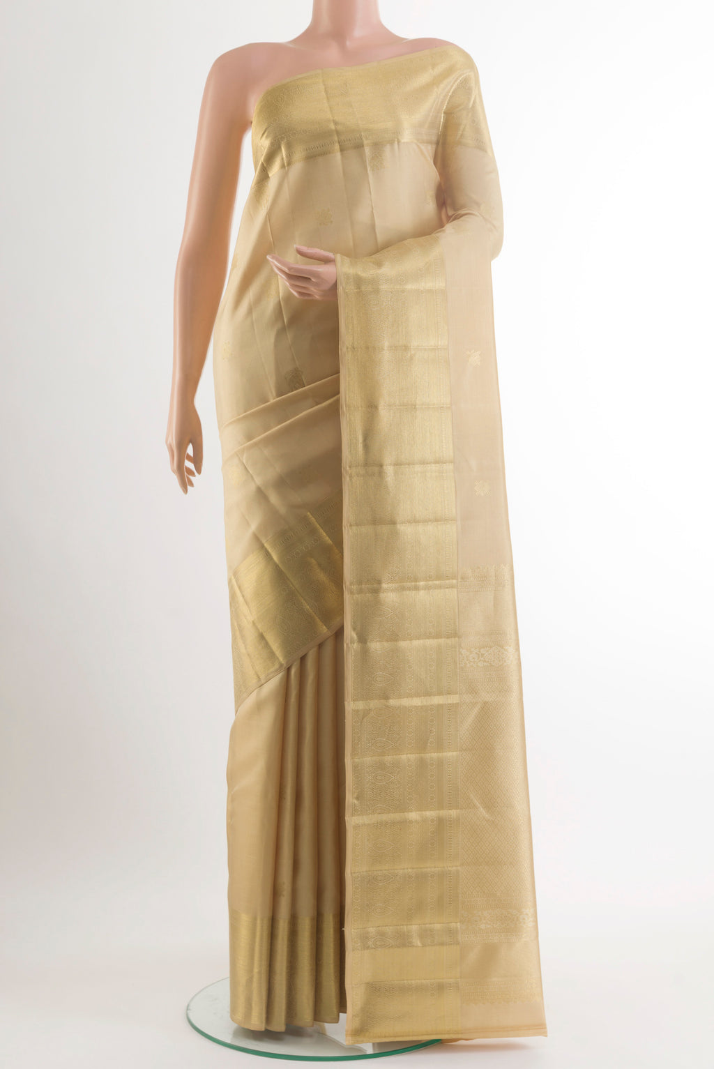 Pure Silk Beige Kanjivaram Saree with Zari Butta on the body and Zari Border.  displayed on a mannequin