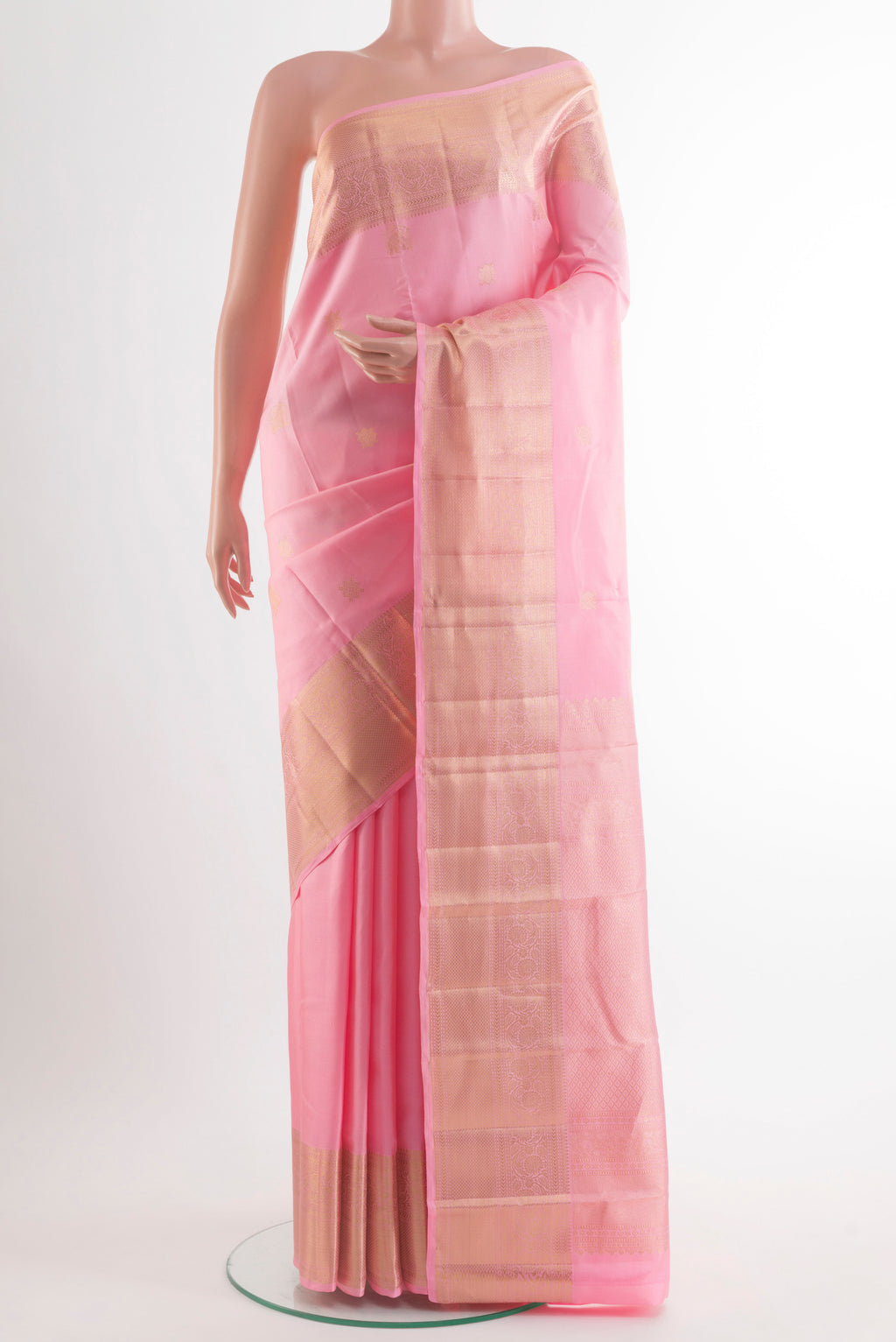 Pure Silk Peach Kanjivaram Saree with Zari Butta on the body and Zari Border.  displayed on a mannequin