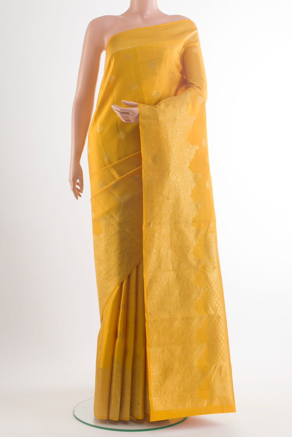 Pure Silk Mustard Kanchipuram Saree with Zari Butta on the body and Zari Border.  displayed on a mannequin