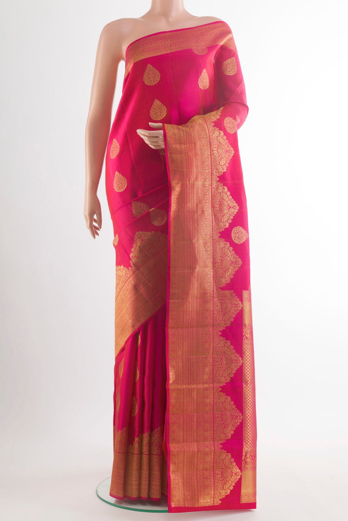 Pure Silk Pink Kanchipuram Saree with Zari Butta on the body and Zari Border.  displayed on a mannequin