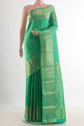Pure Silk Green Kanchipuram Saree with Zari Brocade on the body and Zari Border.  displayed on a mannequin
