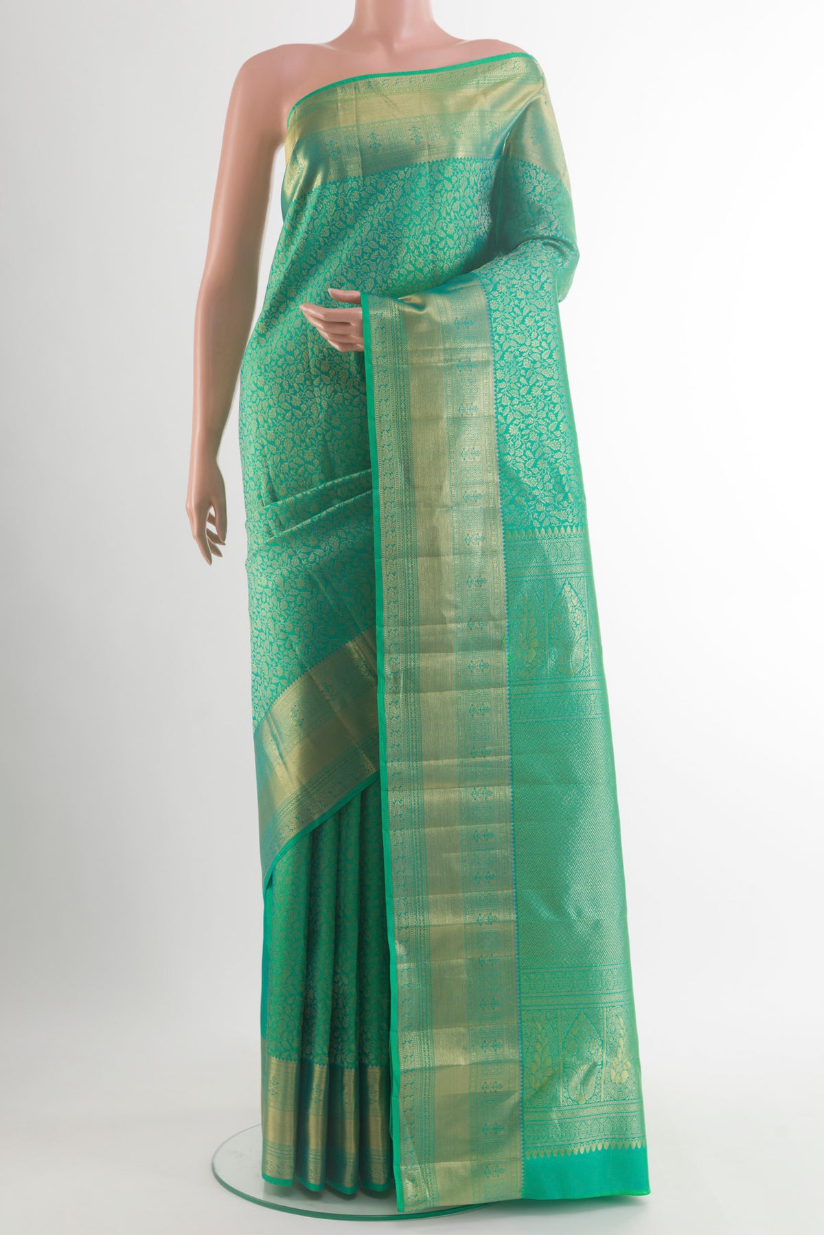 Pure Silk Green Kanchipuram Saree with Zari Brocade on the body and Zari Border.  displayed on a mannequin