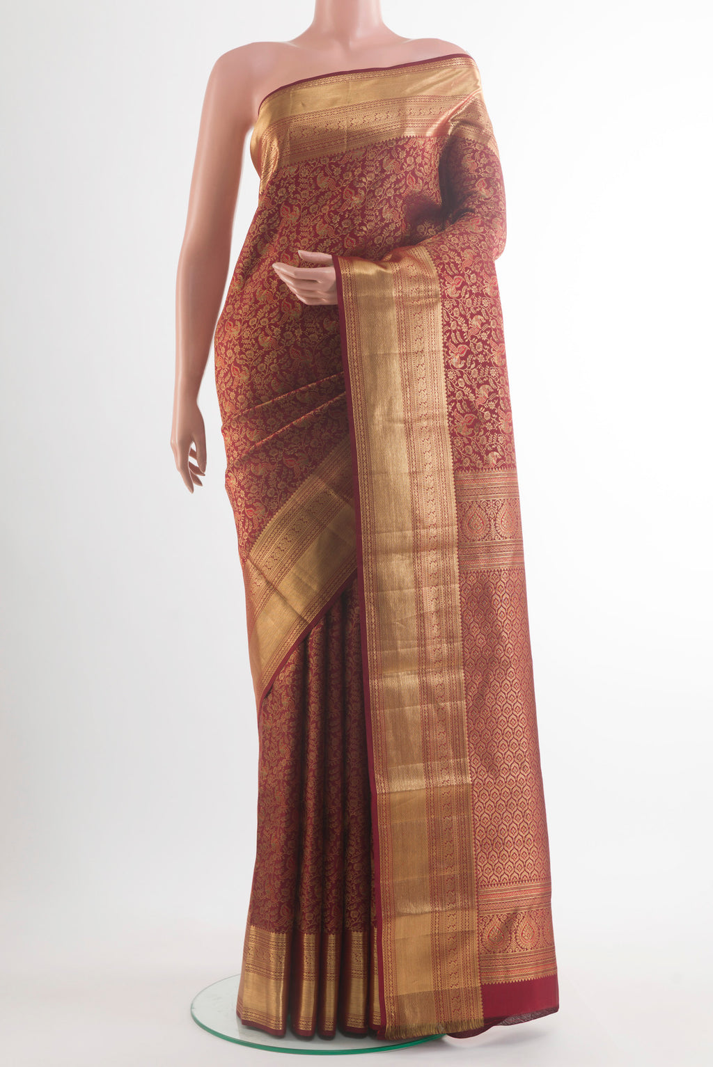 Pure Silk Maroon Kanchipuram Saree with Zari Brocade on the body and Zari Border.  displayed on a mannequin
