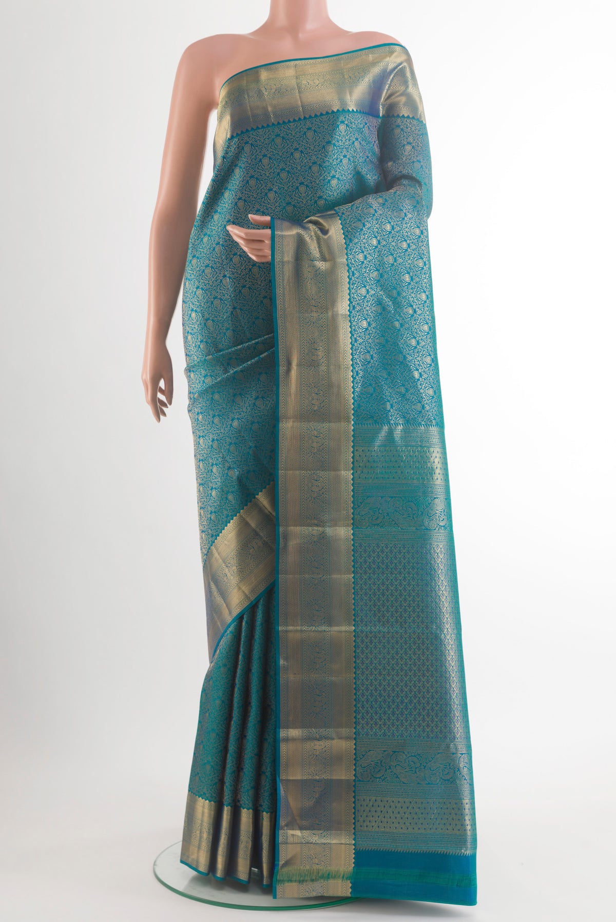 Pure Silk Peacock Blue Kanchipuram Saree with Zari Brocade on the body and Zari Border.  displayed on a mannequin