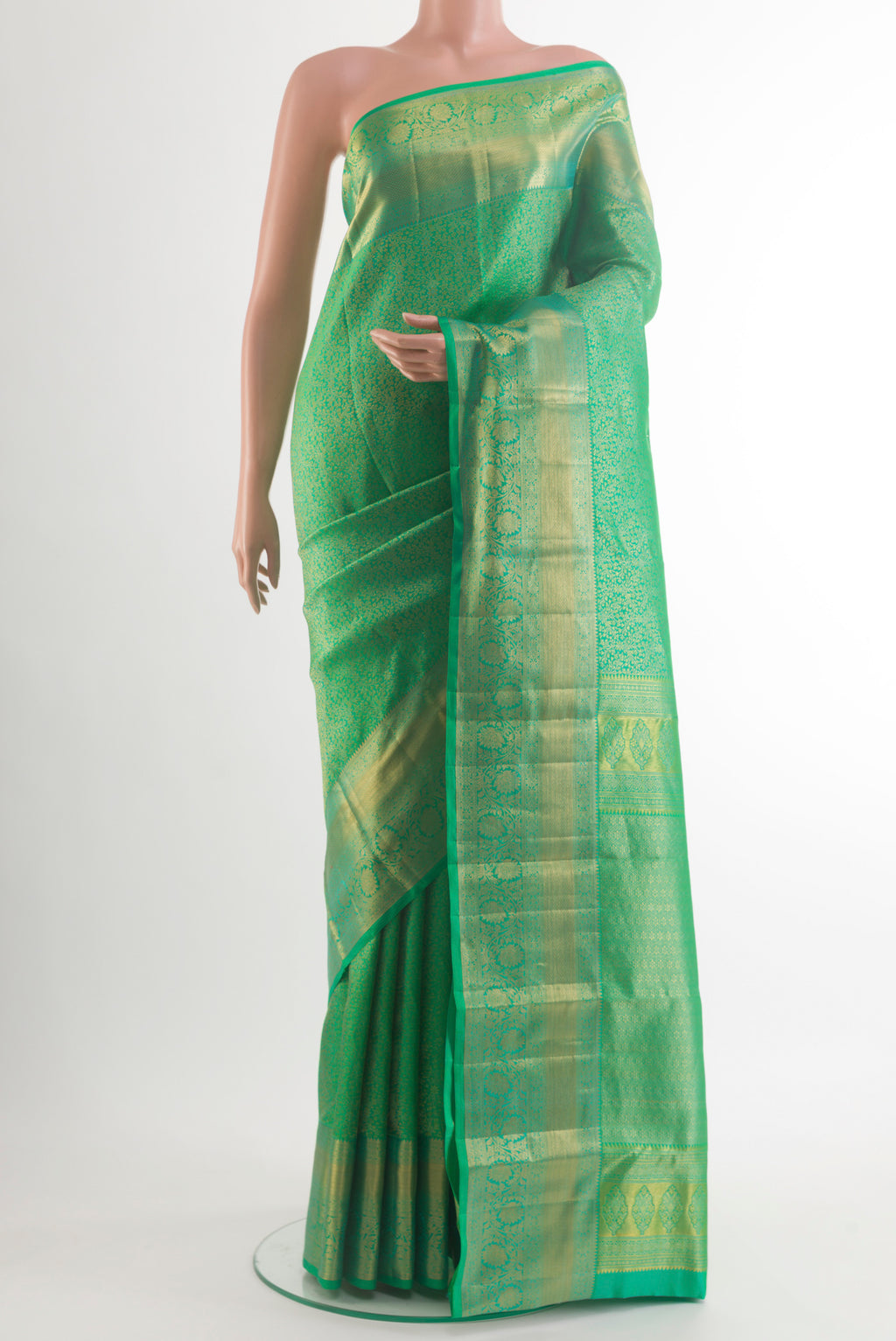 Pure Silk Green Kanchipuram Saree with Zari Brocade on the body and Zari Border.  displayed on a mannequin