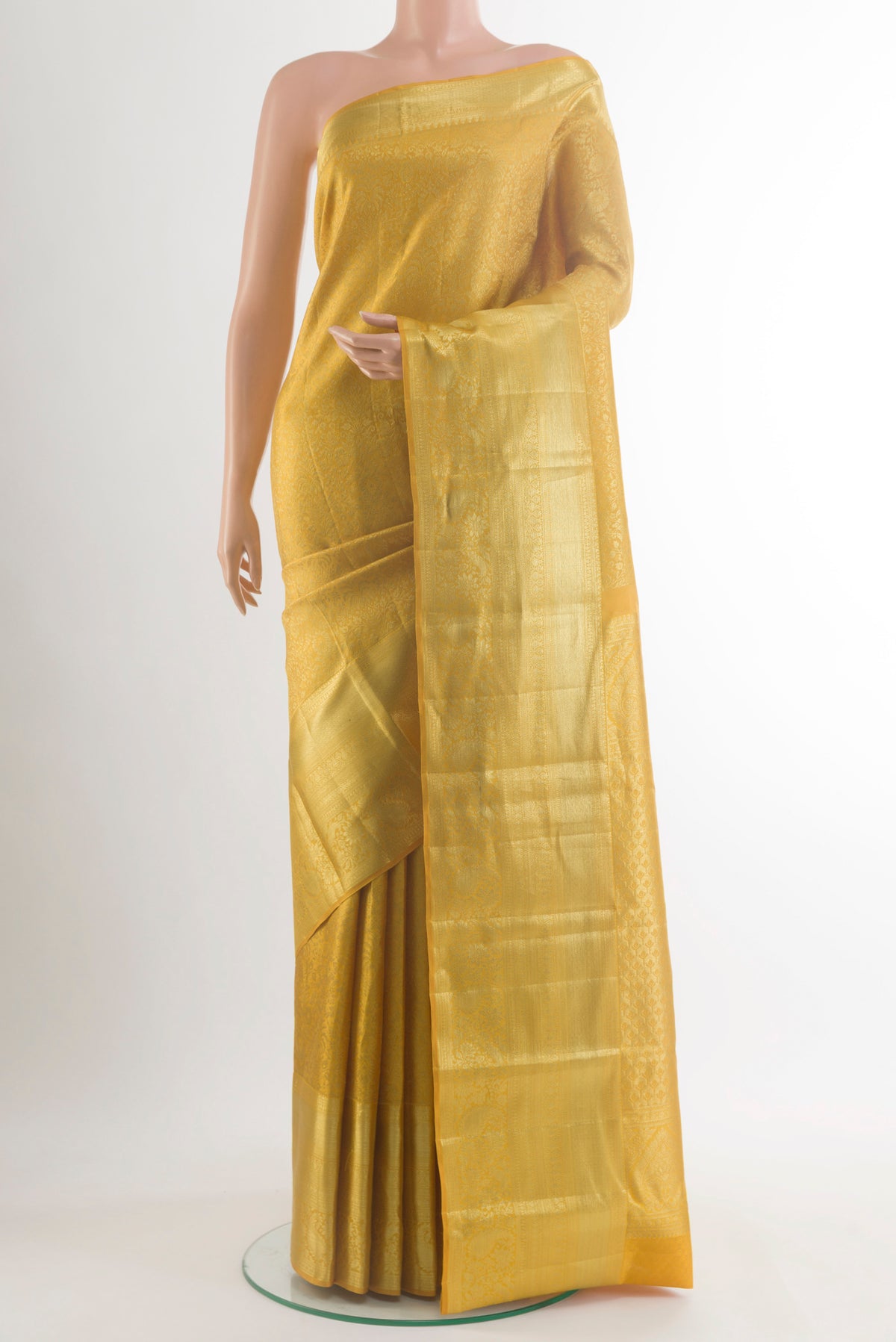 Pure Silk Mustard Kanchipuram Saree with Zari Brocade on the body and Zari Border.  displayed on a mannequin