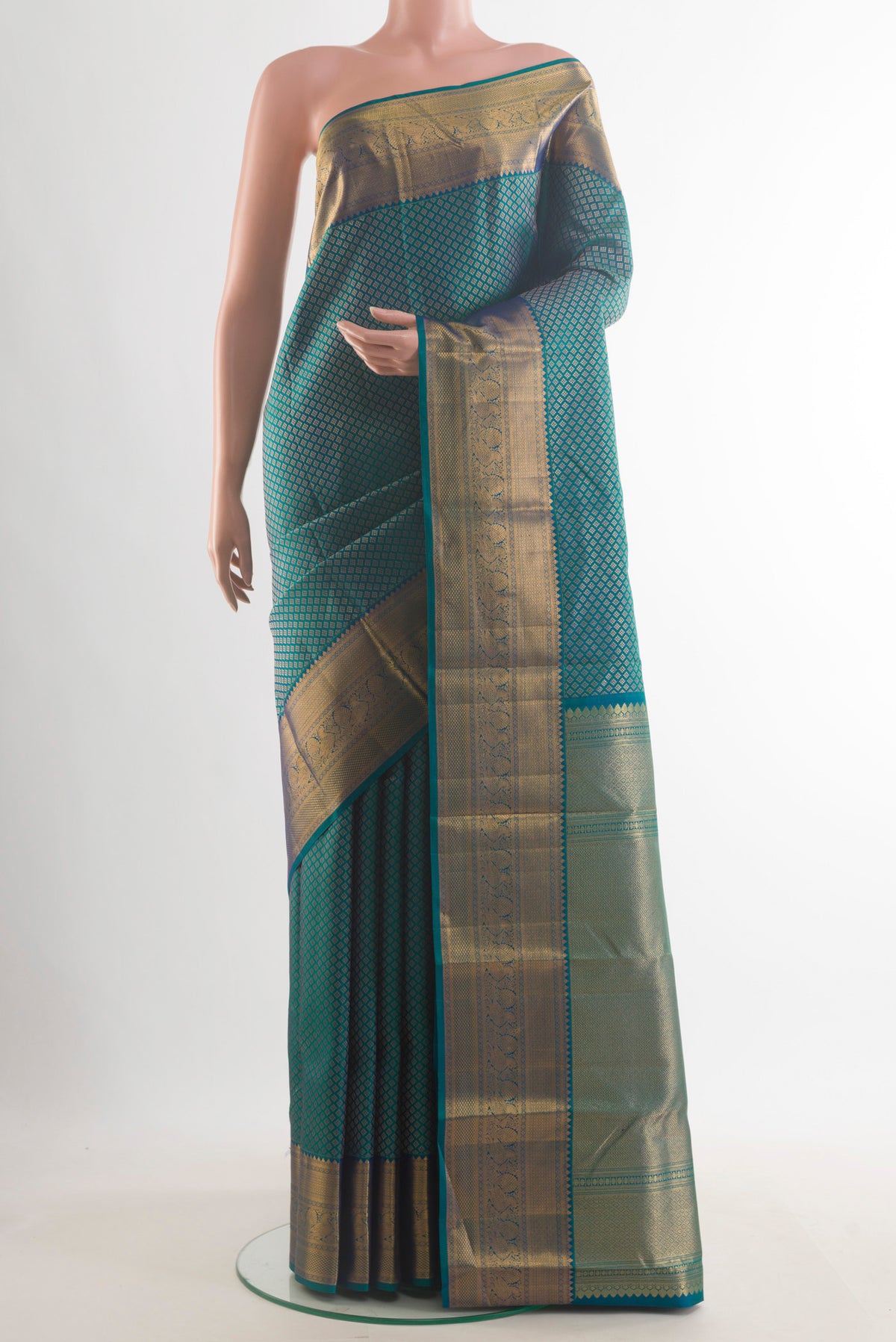 Pure Silk Peacock Blue Dual Tone Kanchipuram Saree with Zari Butta on the body and Zari Border.  displayed on a mannequin