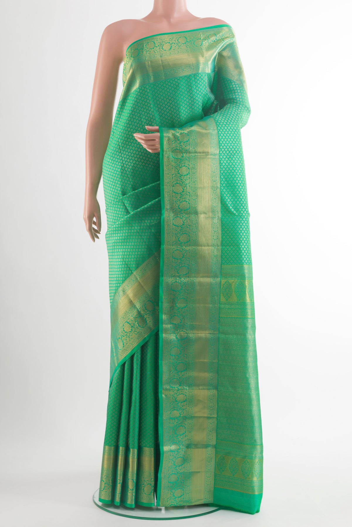 Pure Silk Green Kanchipuram Saree with Zari Brocade on the body and Zari Border.  displayed on a mannequin