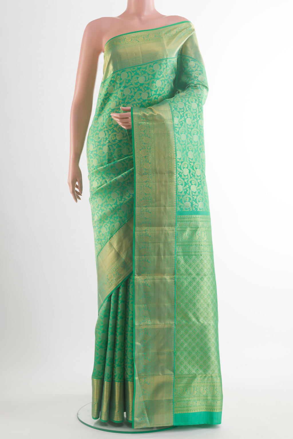 Pure Silk Green Kanchipuram Saree with Zari Brocade on the body and Zari Border.  displayed on a mannequin