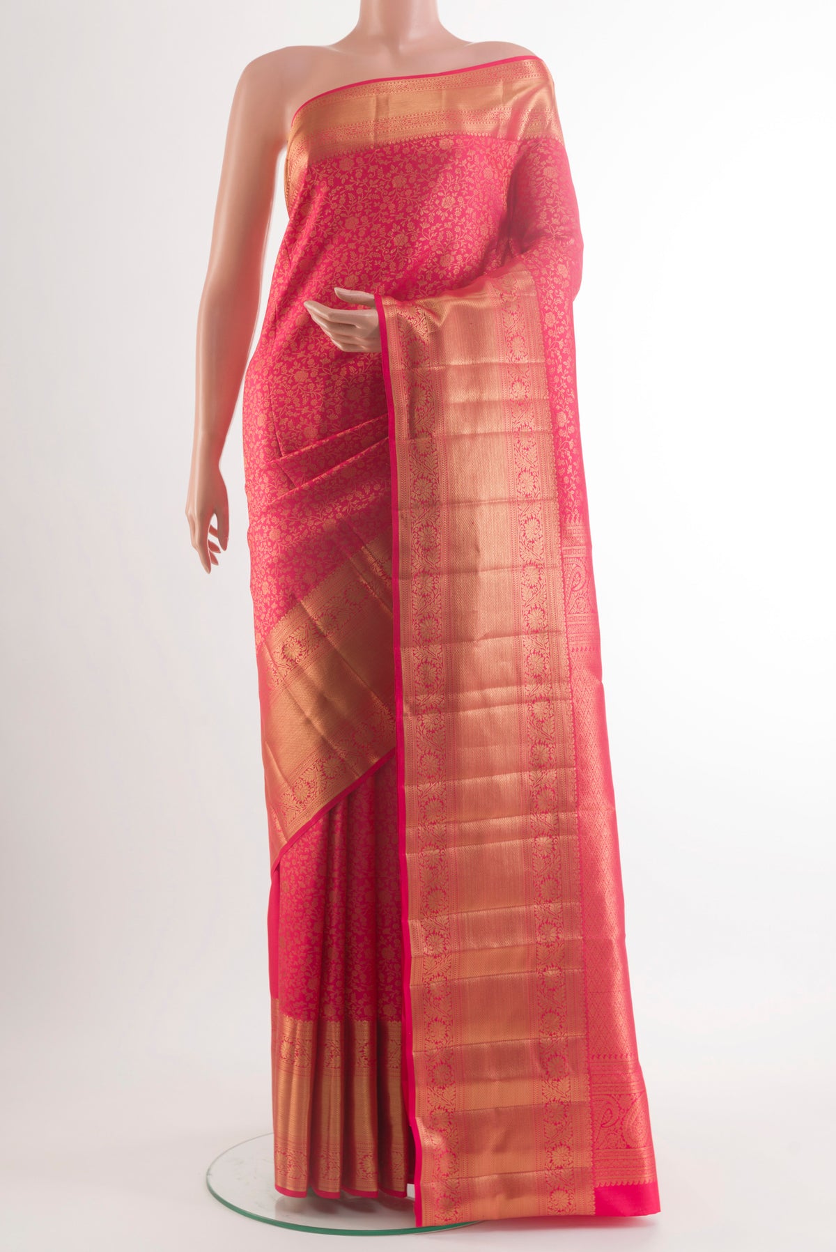 Pure Silk Pink Kanchipuram Saree with Zari Butta on the body and Zari Border.  displayed on a mannequin