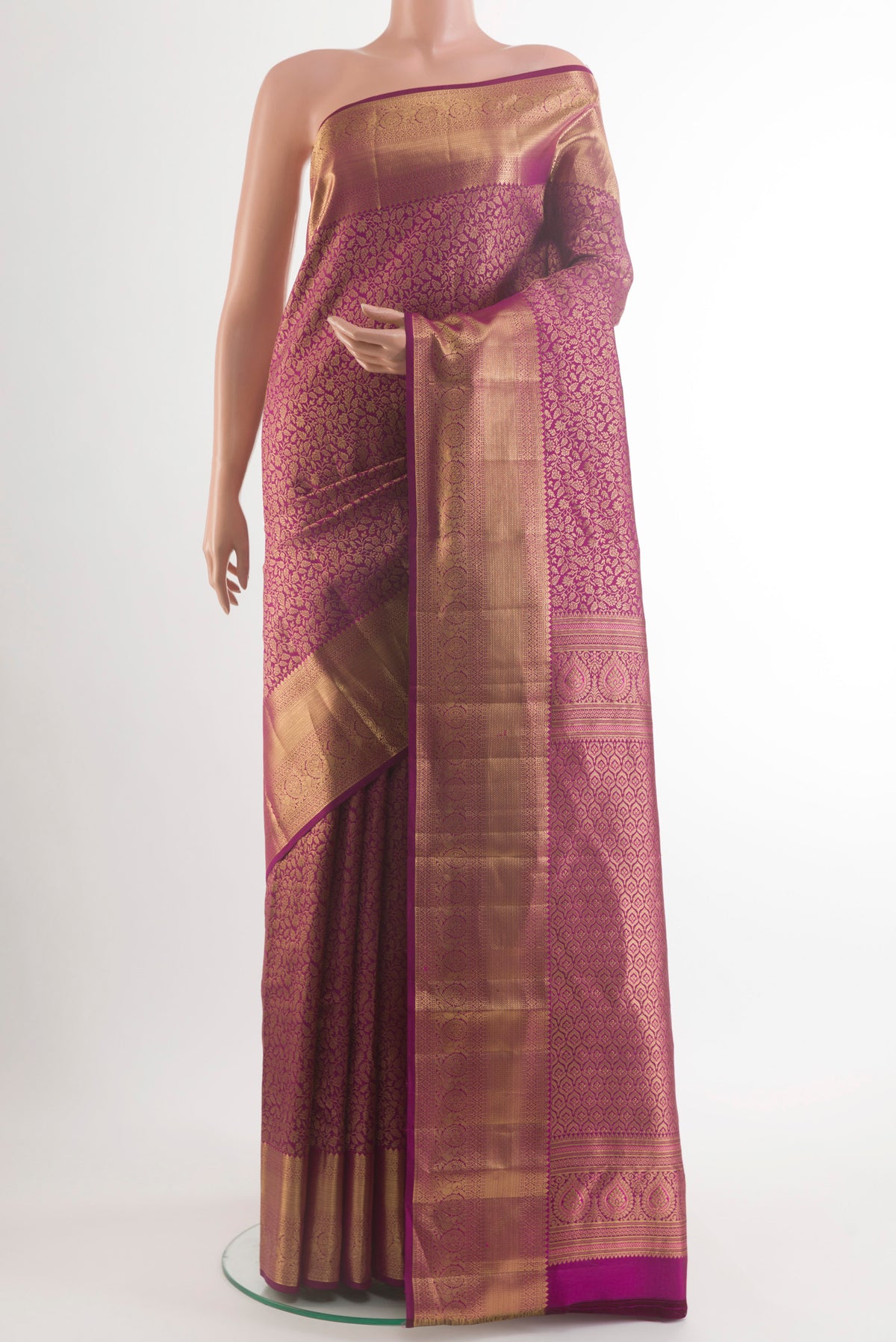 Pure Silk Magenta Kanchipuram Saree with Zari Brocade on the body and Zari Border.  displayed on a mannequin