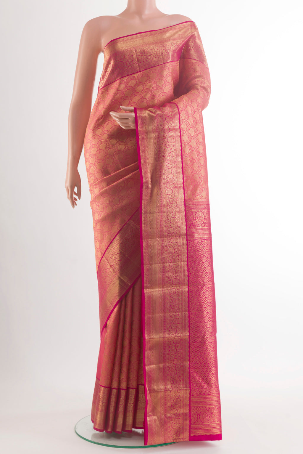 Pure Silk Coral Kanchipuram Saree with Zari Brocade on the body and Zari Border.  displayed on a mannequin