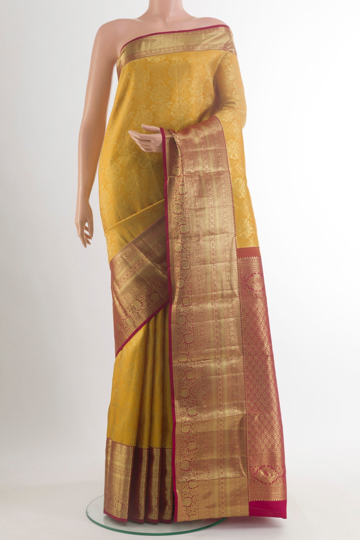 Pure Silk Yellow Kanchipuram Saree with Zari Brocade on the body and Zari Border.  displayed on a mannequin