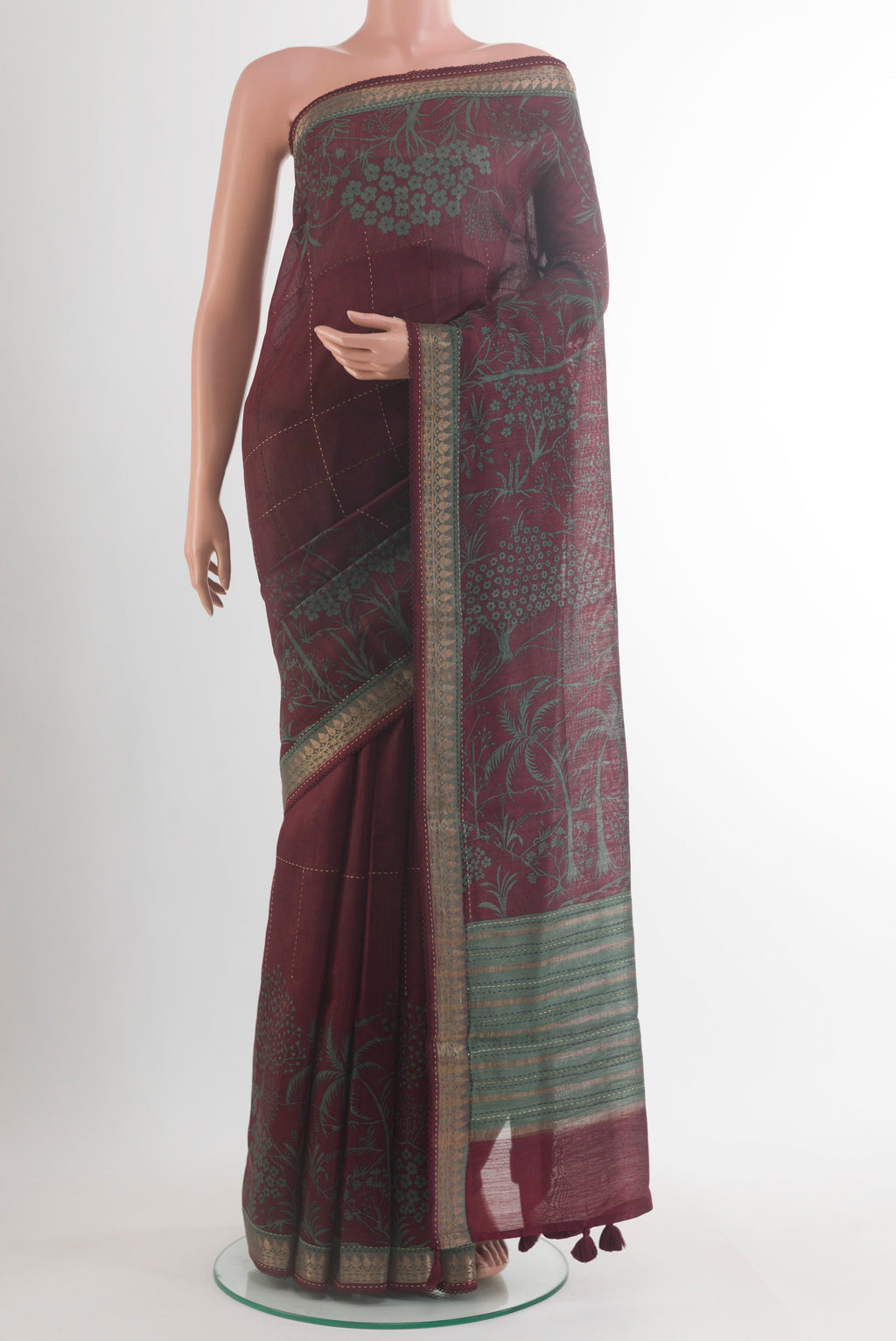 Maroon Tussar Saree with Checked design on the body and Zari Border.  displayed on a mannequin