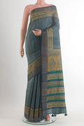 Green Tussar Saree with Checked design on the body and Printed Border.  displayed on a mannequin