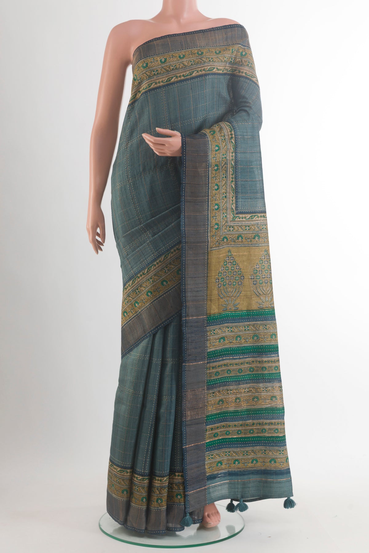 Green Tussar Saree with Checked design on the body and Printed Border.  displayed on a mannequin