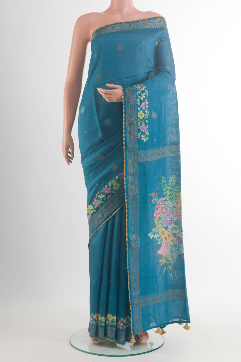 Blue Tussar Saree with Thread Butta on the body and Zari Border.  displayed on a mannequin