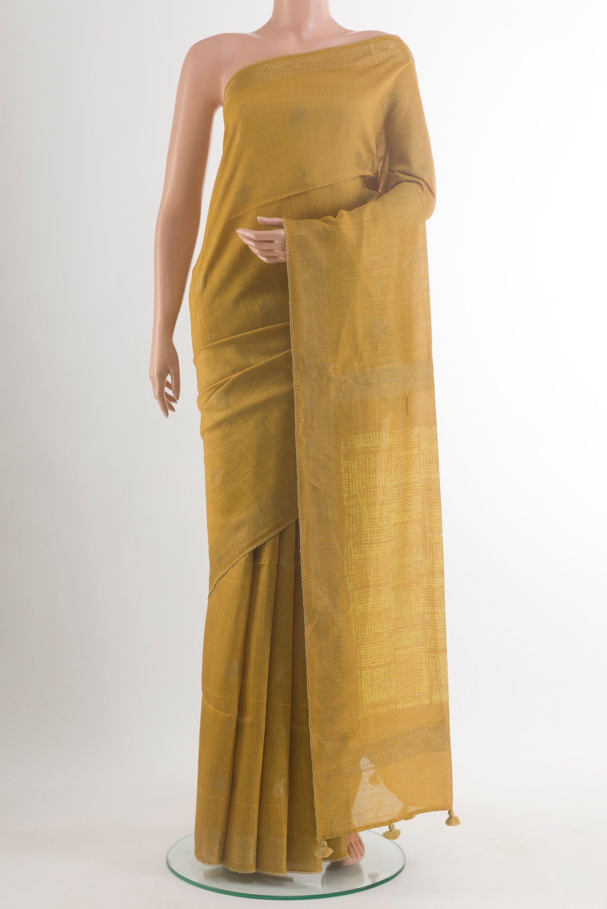 Mustard Tussar Saree with Zari Butta on the body and Zari Border.  displayed on a mannequin