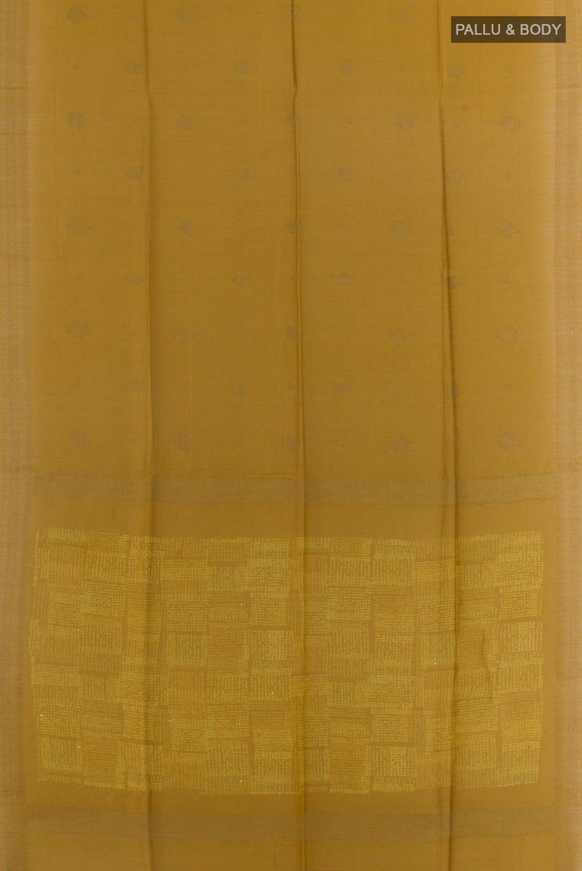 Flat view of Mustard Tussar Saree with Zari Butta on the body and Zari Border. 