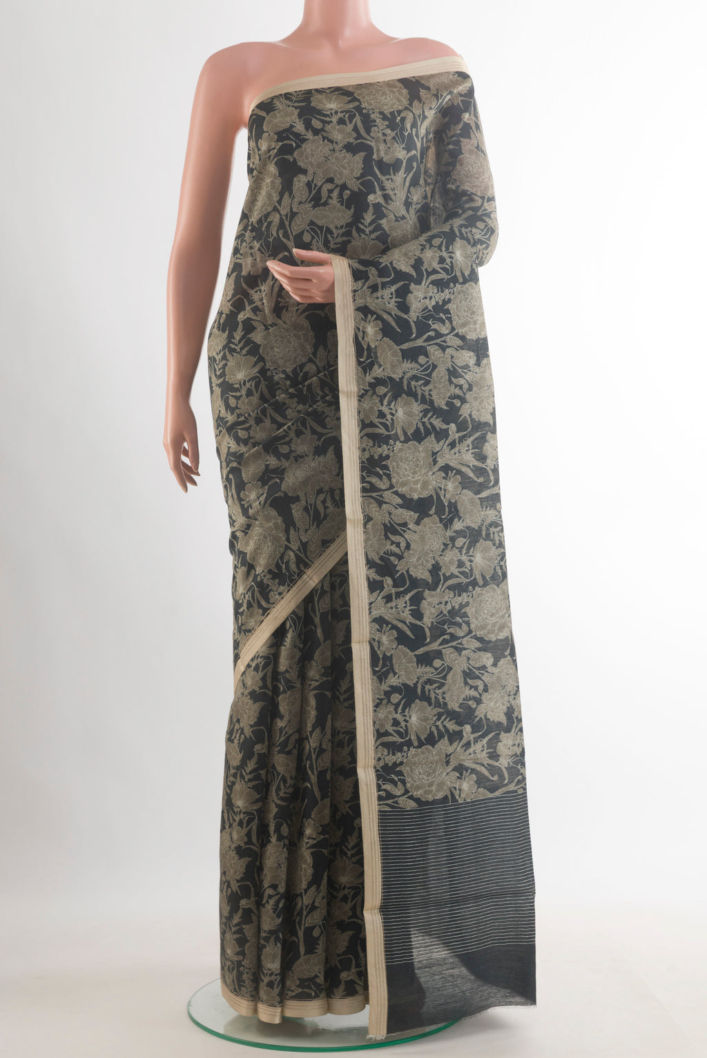 Black Tussar Saree with Printed design on the body and Thread Border.  displayed on a mannequin