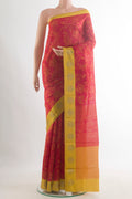 Red Tussar Saree with Printed design on the body and Zari Border.  displayed on a mannequin