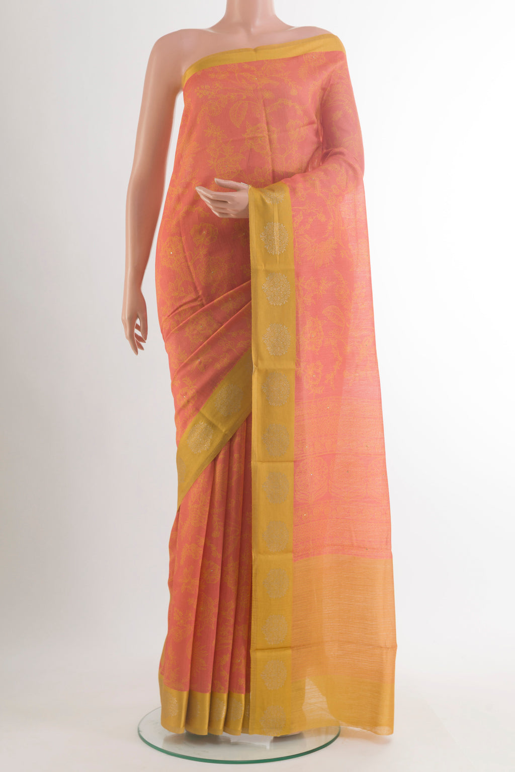 Peach Tussar Saree with Printed design on the body and Zari Border.  displayed on a mannequin