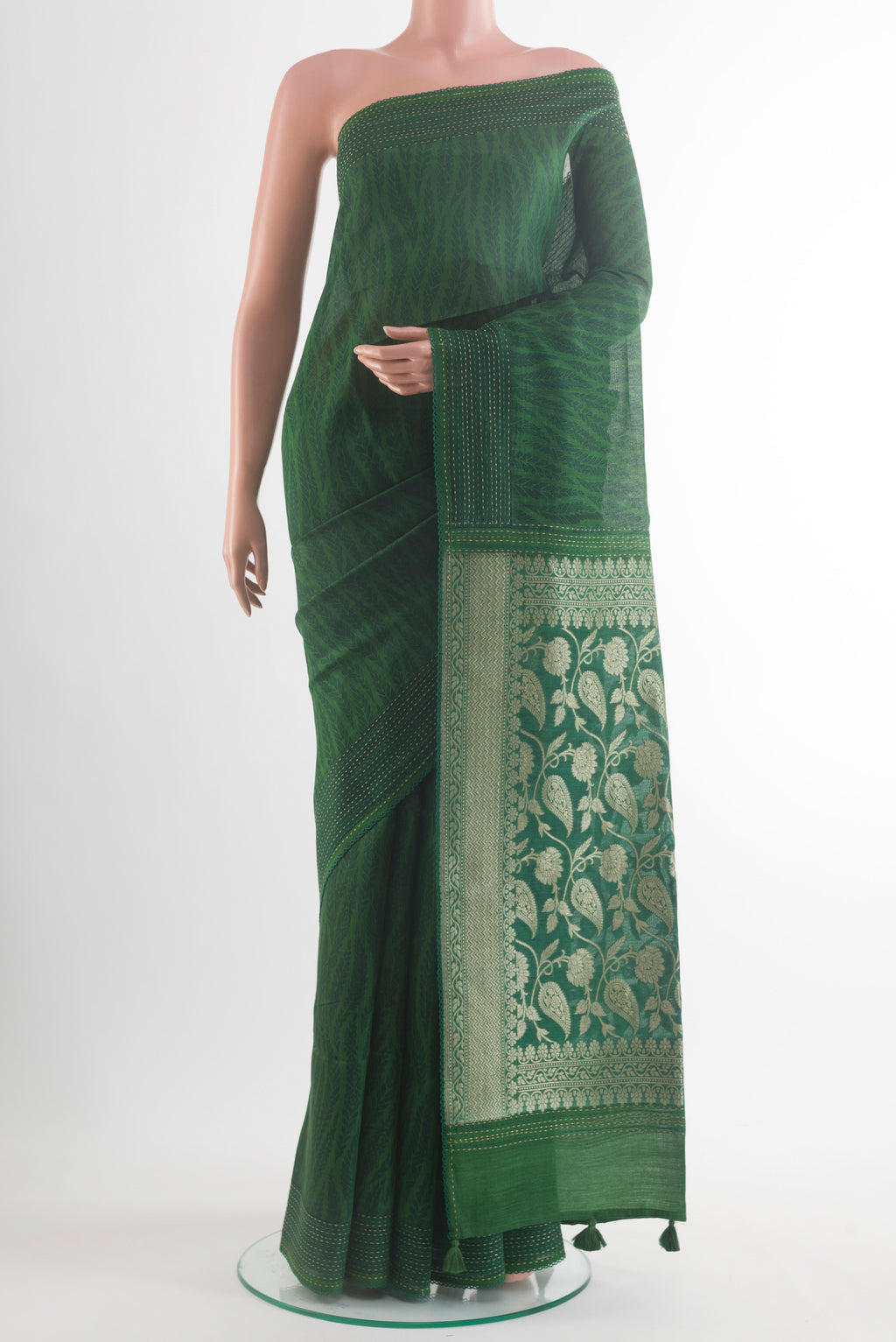 Green Tussar Saree with Printed design on the body and Embroidery Border.  displayed on a mannequin