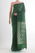 Green Tussar Saree with Printed design on the body and Embroidery Border.  displayed on a mannequin