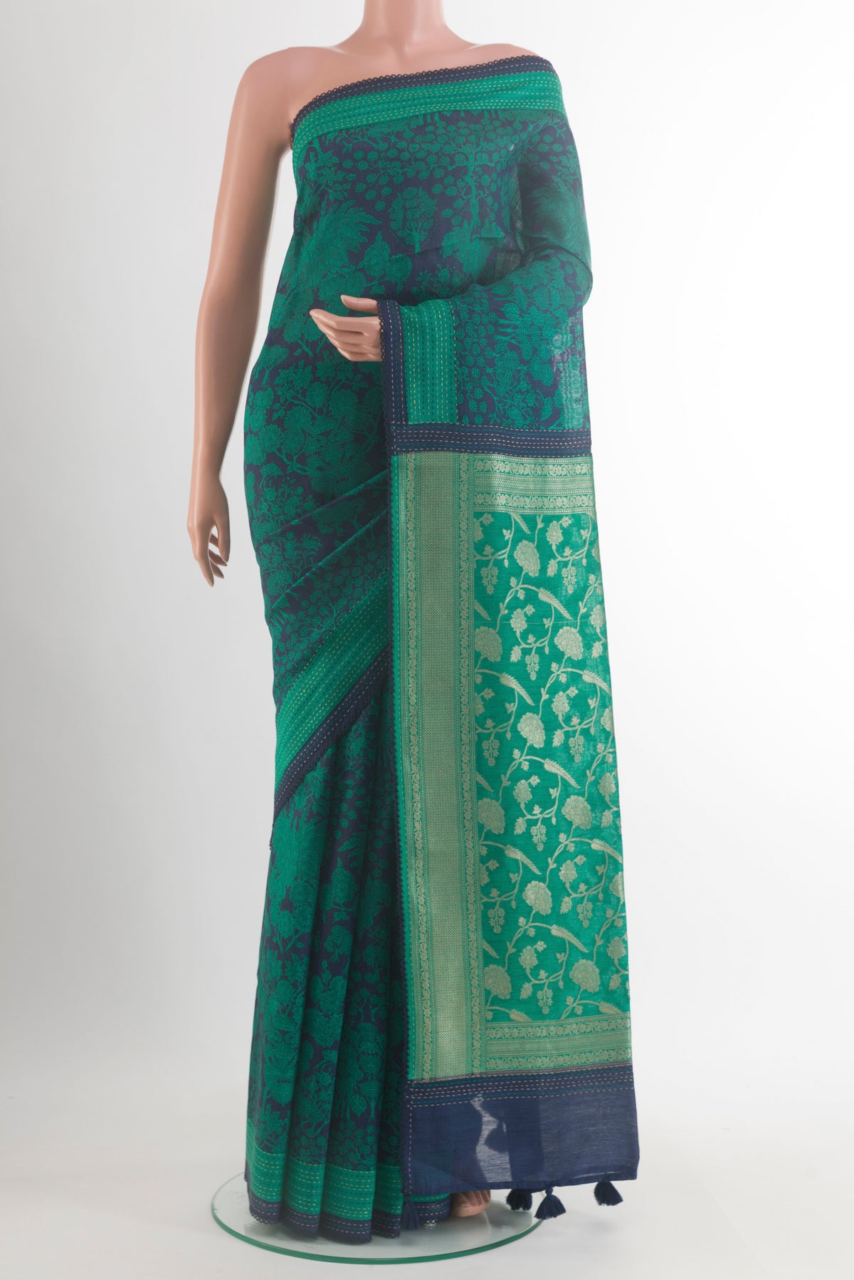 Navy Blue Tussar Saree with Floral Print on the body and Zari Border.  displayed on a mannequin