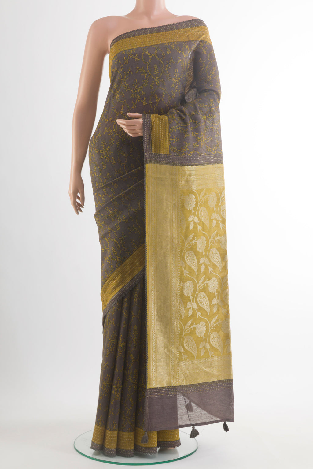 Grey Tussar Saree with Printed design on the body and Zari Border.  displayed on a mannequin