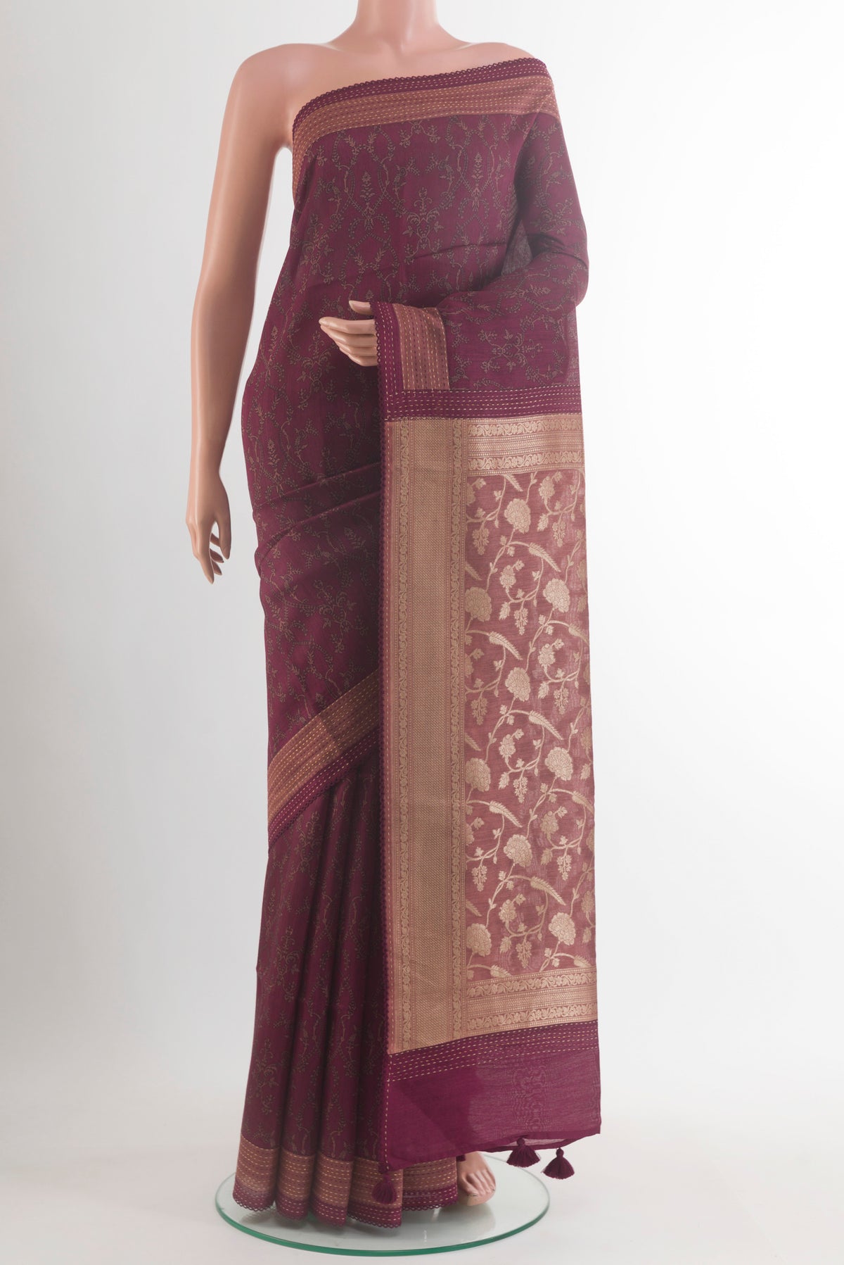 Maroon Tussar Saree with Printed design on the body and Thread Border.  displayed on a mannequin