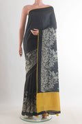 Black Tussar Saree with Plain Body and Printed Border.  displayed on a mannequin
