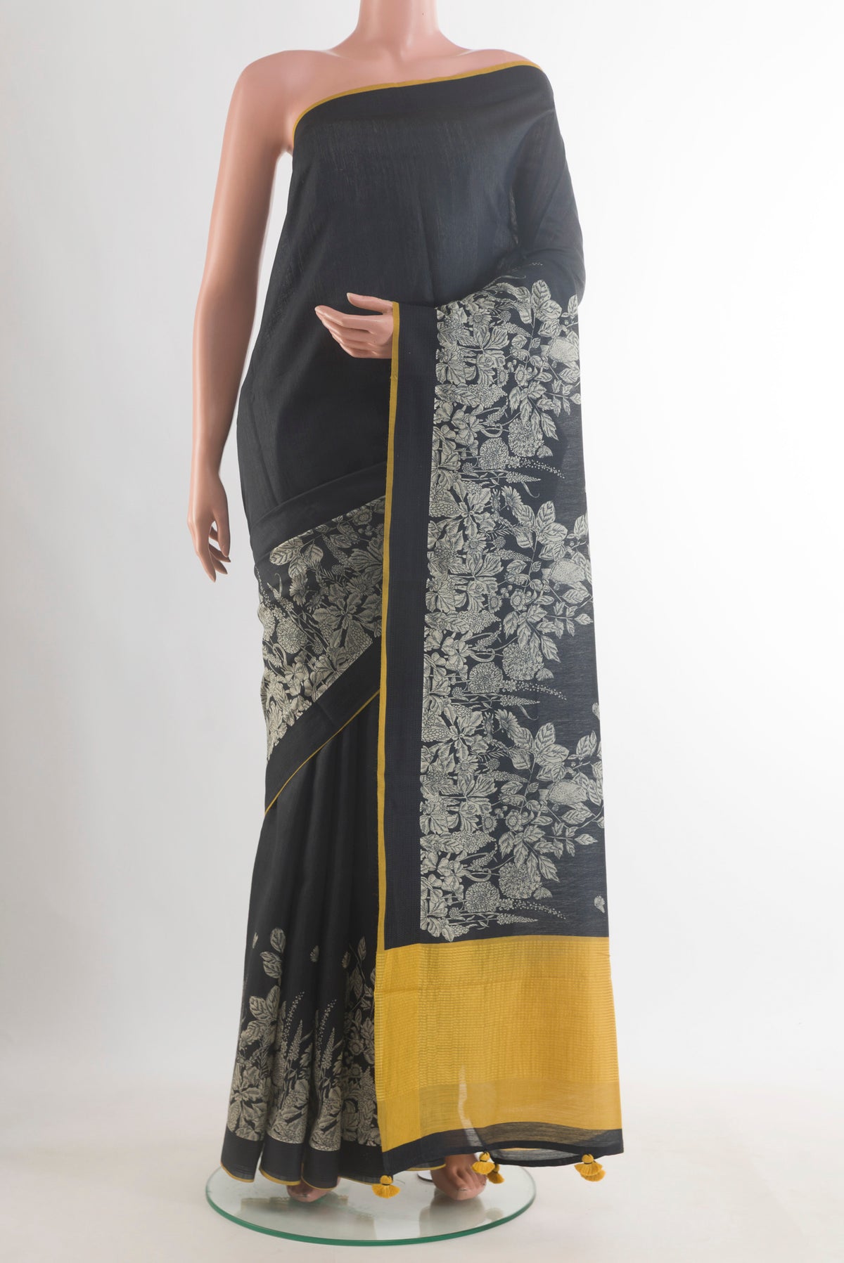 Black Tussar Saree with Plain Body and Printed Border.  displayed on a mannequin