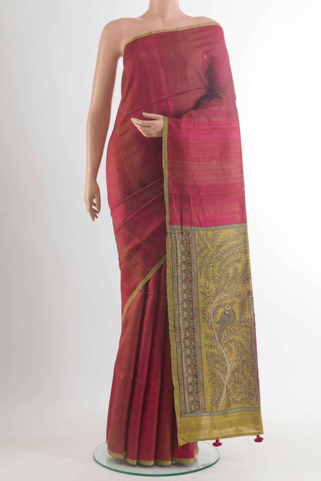 Red Tussar Saree with Zari Butta on the body and Zari Border.  displayed on a mannequin