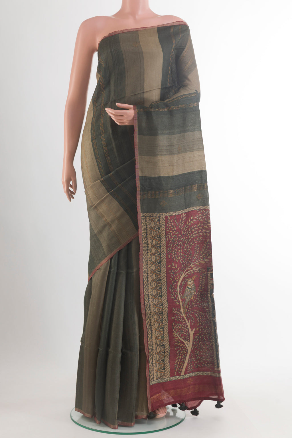 Olive Green Tussar Saree with Stripes on the body and Zari Border.  displayed on a mannequin
