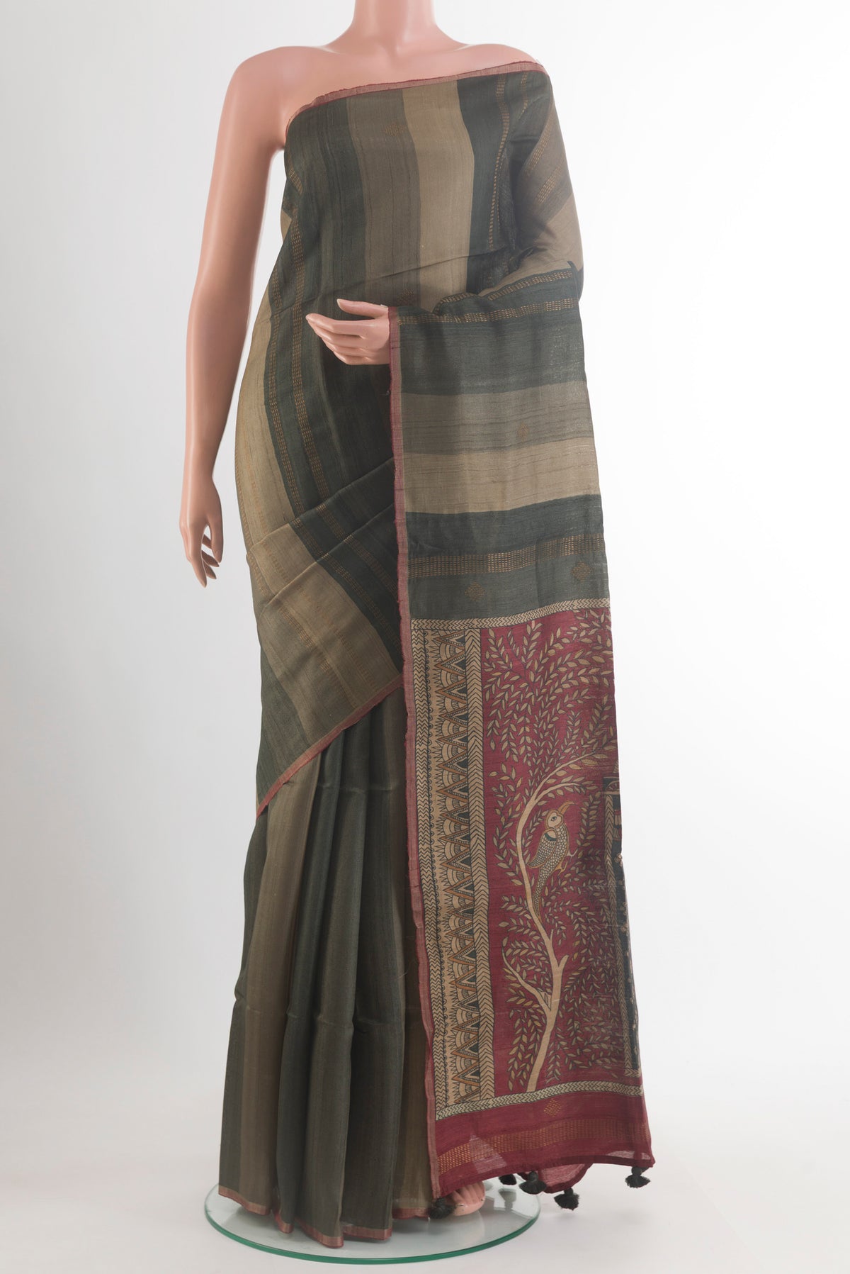 Olive Green Tussar Saree with Stripes on the body and Zari Border.  displayed on a mannequin