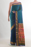 Pure Silk Peacock Blue Dual Tone Paithani Saree with Zari Butta on the body and Zari Border.  displayed on a mannequin
