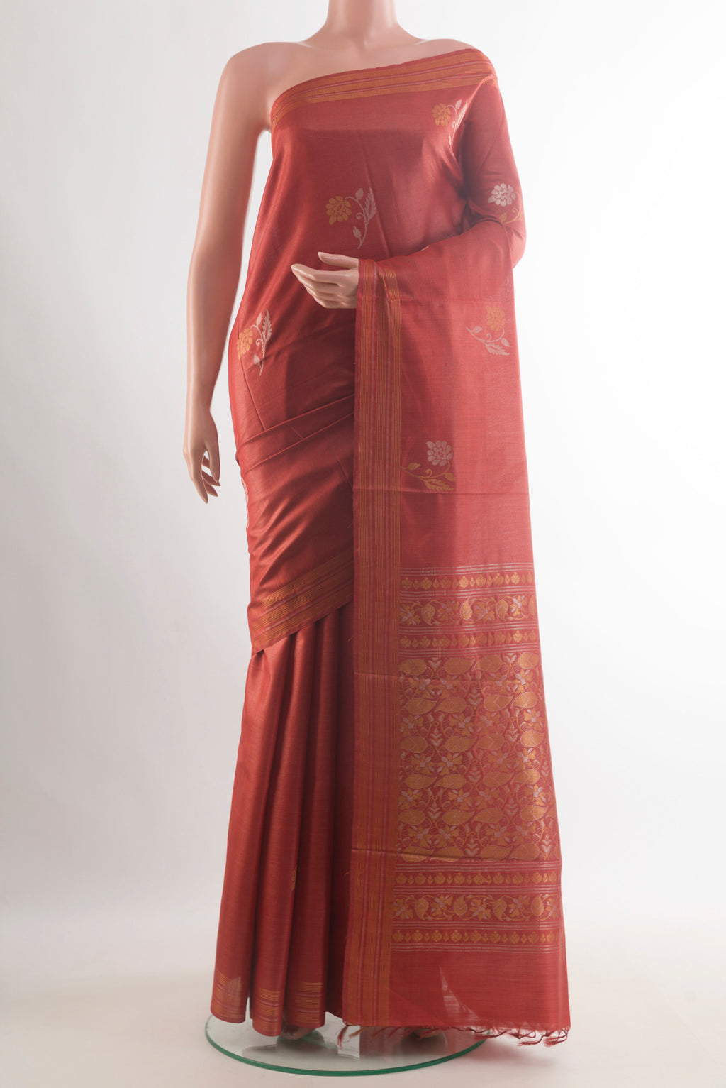 Rust Tussar Saree with Zari Butta on the body and Zari Border.  displayed on a mannequin