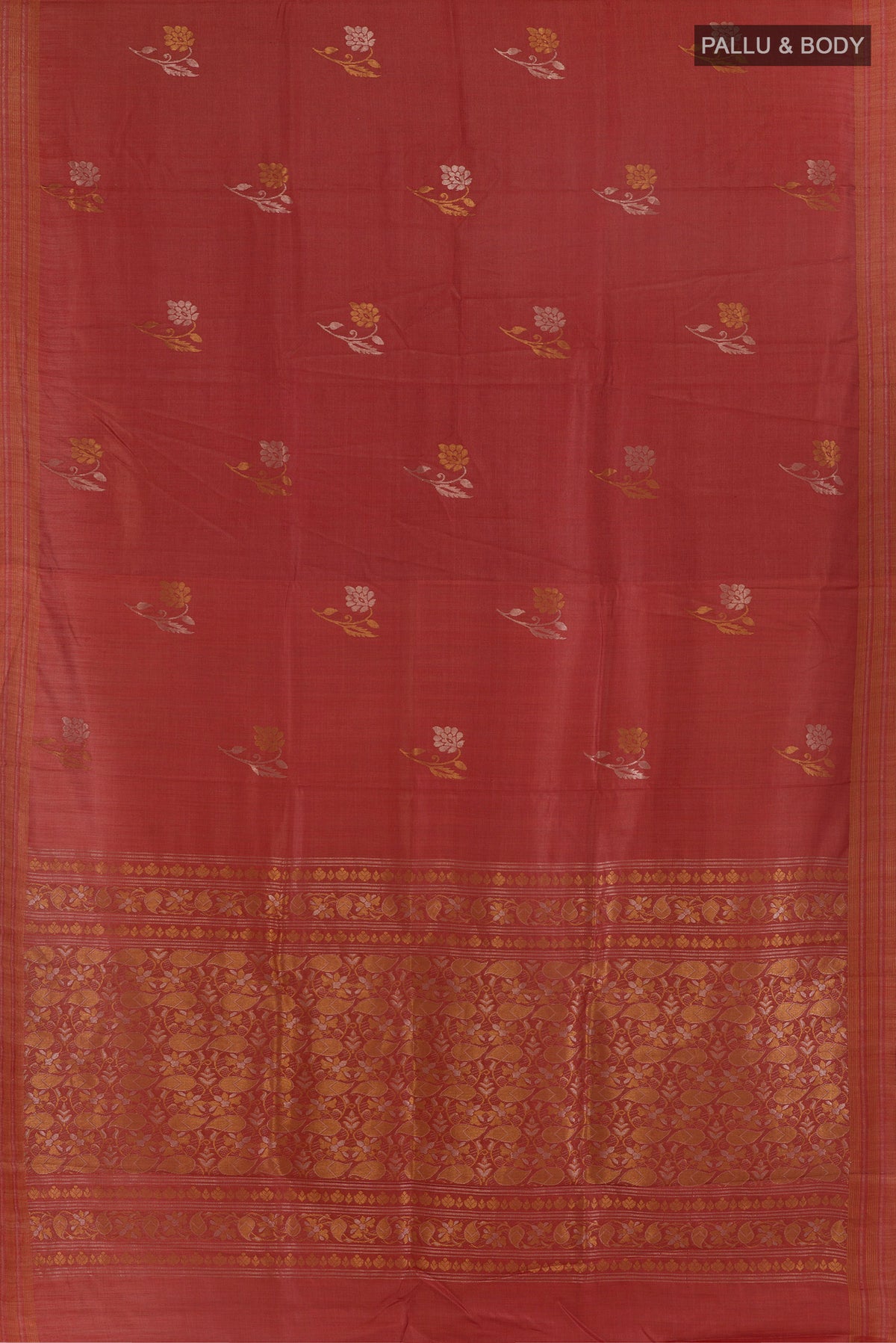 Flat view of Rust Tussar Saree with Zari Butta on the body and Zari Border. 
