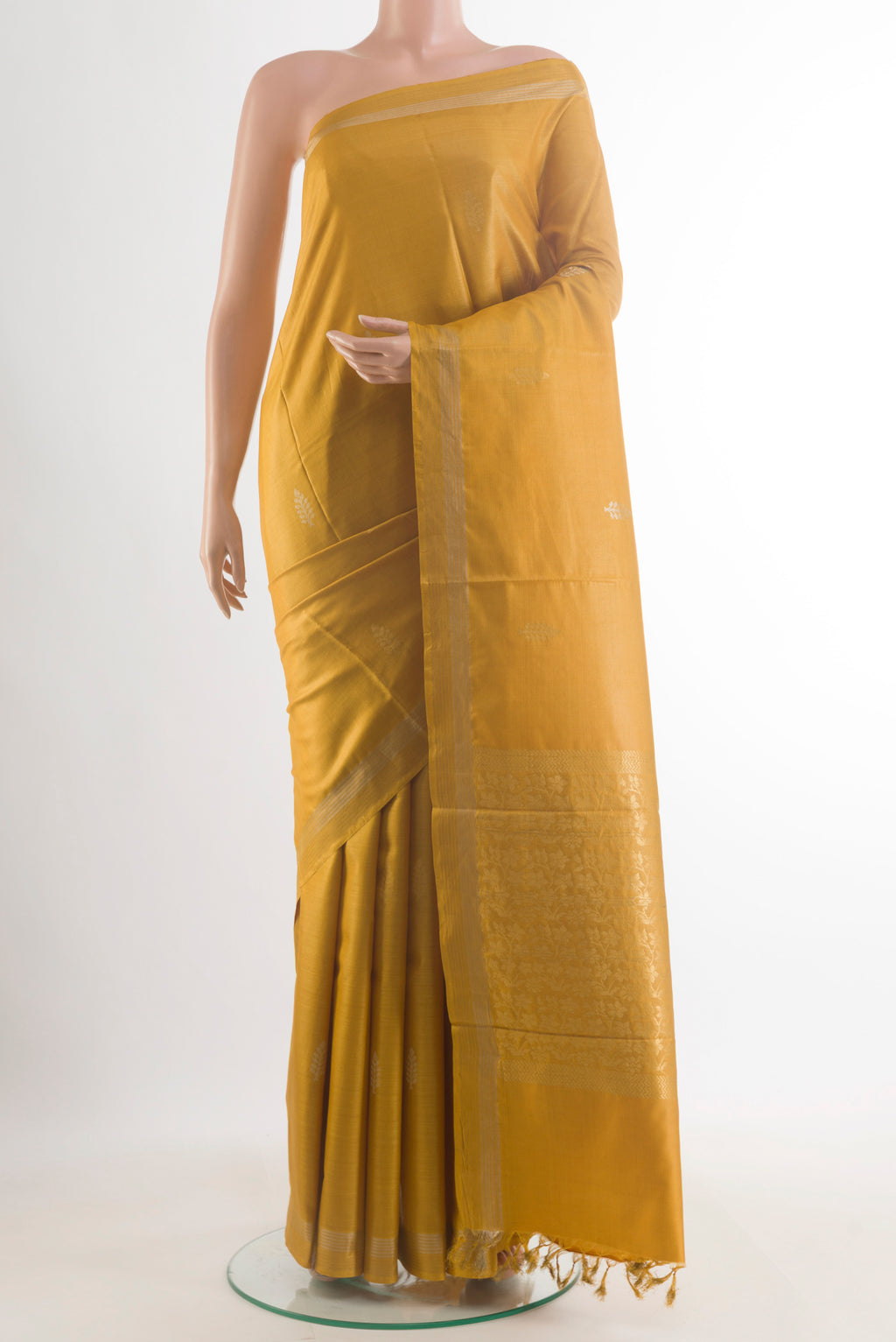 Yellow Tussar Saree with Zari Butta on the body and Zari Border.  displayed on a mannequin