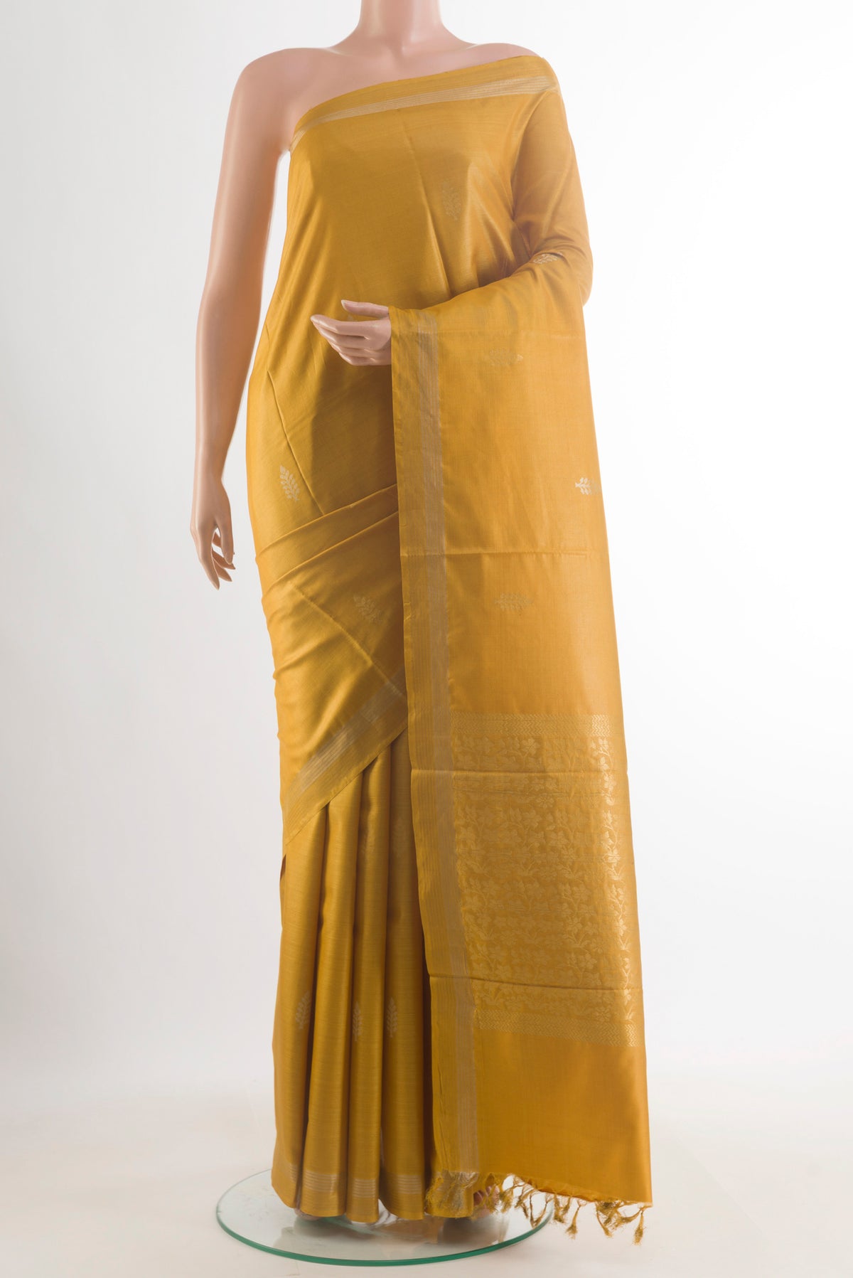 Yellow Tussar Saree with Zari Butta on the body and Zari Border.  displayed on a mannequin