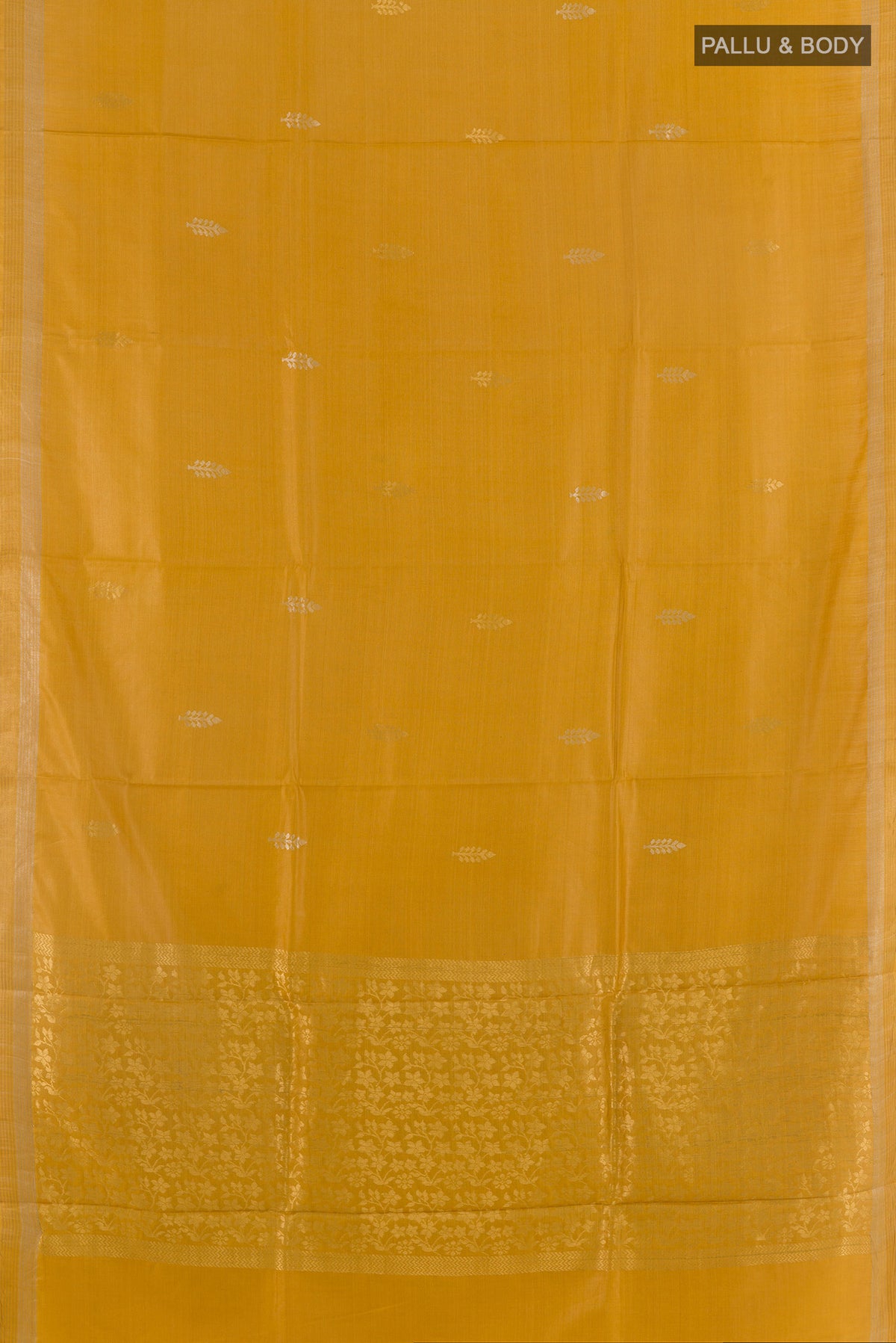 Flat view of Yellow Tussar Saree with Zari Butta on the body and Zari Border. 