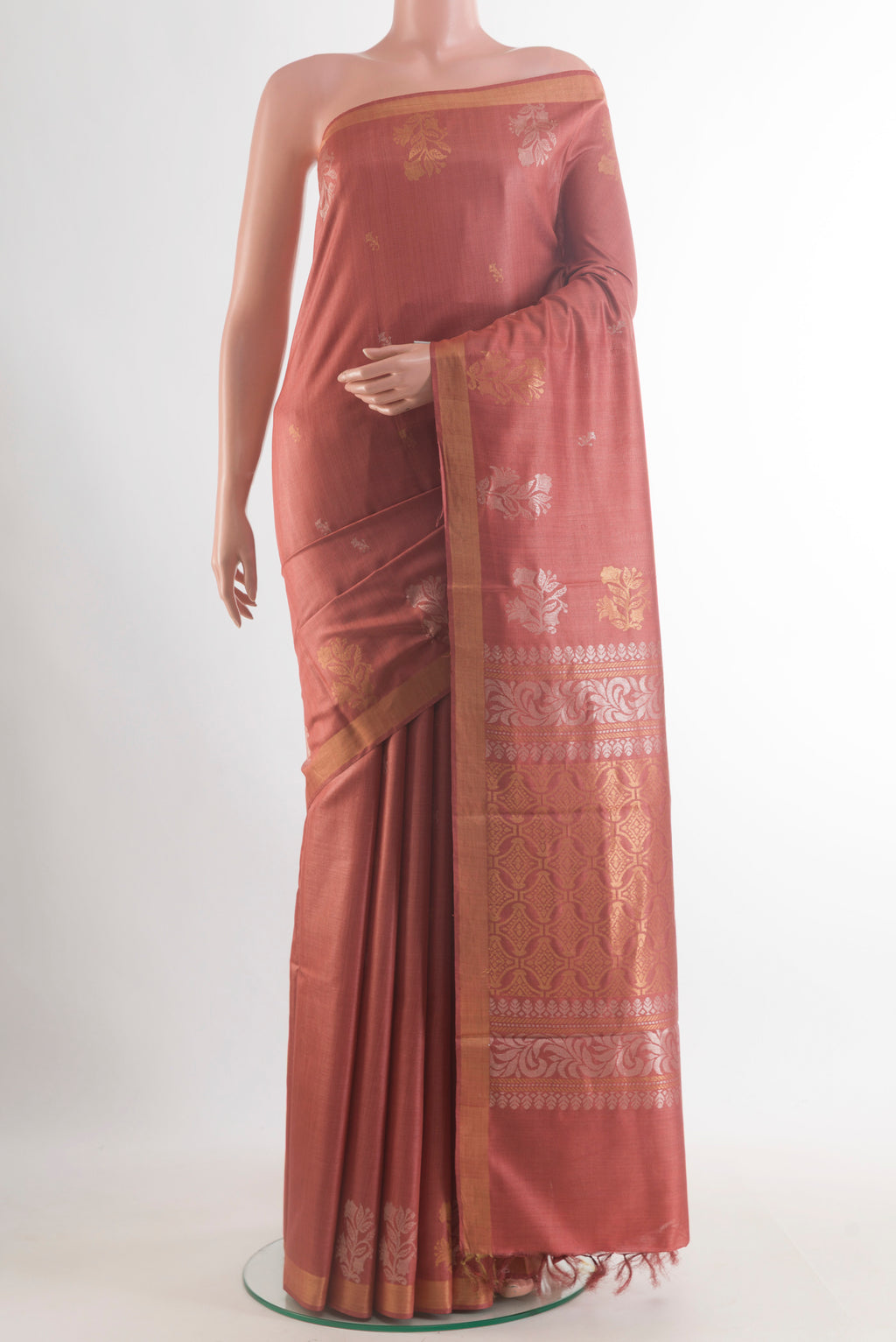 Rust Tussar Saree with Zari Butta on the body and Zari Border.  displayed on a mannequin